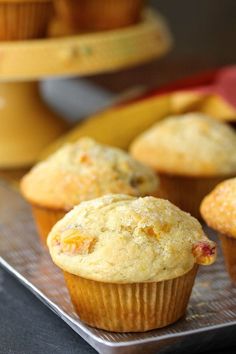 some muffins are sitting on a metal tray