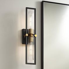 a wall light that is next to a mirror