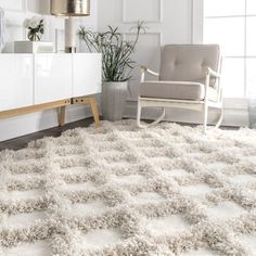 a living room with a chair and rug on the floor