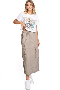 Chic, parachute skirt with an elastic waistband, a drawstring cinch tie and cargo pockets down the sides. Pair it with a graphic tee and sneakers for an effortless streetwear look. CARE | Machine Wash Cold CONTENTS | 100% Nylon MEASUREMENTS | 33"/85 cm Top to Bottom (Size Small) MODEL | 5'8 - wearing a size Small IMPORTED Sporty Summer Cargo Pants With Drawstring, Summer Utility Cargo Skirt With Drawstring, Casual Cargo Skirt With Drawstring For Summer, Casual Drawstring Cargo Skirt For Summer, Casual Summer Cargo Skirt With Drawstring, Casual Nylon Cargo Pants For Summer, Summer Cargo Pants With Functional Drawstring For Streetwear, Casual Summer Cargo Pants With Functional Drawstring, Summer Casual Nylon Cargo Pants