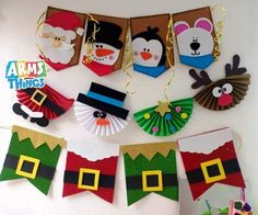 christmas decorations are hanging on the wall with santa claus and snowman paper fans in front of them