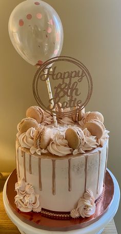 a birthday cake with white frosting and pink icing