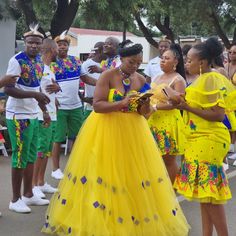 several people dressed in brightly colored clothing standing together