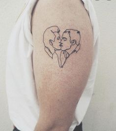 a woman with a tattoo on her arm has a heart shaped drawing of two people