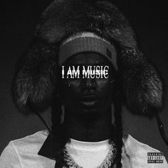 a man wearing a fur hat with the word i am music on it's forehead