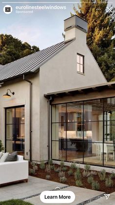 an image of a modern house with glass doors and windows on the front door,