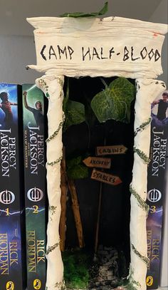 the bookcase is made to look like a camp half - blood sign and has plants growing out of it