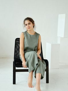 "Moss green sleeveless linen top. Handmade linen basic tank top. Height of my model - 170 cm. / size - S Choose size: XS Bust 82 - 84 cm. ( 32 1/4\" - 33\") Waist 66 - 68 cm. / (26\" - 26 3/4\") Hips 90 - 92 cm. / (35 1/2\" - 36 1/4\") S Bust 86 - 88 cm. ( 33 3/4\" - 34 3/4\") Waist 70 - 72 cm. / (27 3/4\" - 28 1/4\") Hips 94 - 96 cm. / (37\" - 37 3/4\") M Bust 90 - 92 cm. ( 35 1/2\" - 36 1/4\") Waist 74 - 76cm. / (29 1/4\" - 30\") Hips 98 - 100 cm. / (38 1/2\" - 39 1/4\") L Bust 94 - 96 cm. ( 3 Solid Linen Sleeveless Tank Top, Solid Color Linen Sleeveless Tank Top, Sleeveless Linen Tank Top, Green Linen Tank Top For Summer, Green Sleeveless Linen Casual Dress, Green Sleeveless Linen Top, Green Sleeveless Linen Dress For Summer, Casual Green Sleeveless Linen Dress, Green Sleeveless Linen Dress For Spring