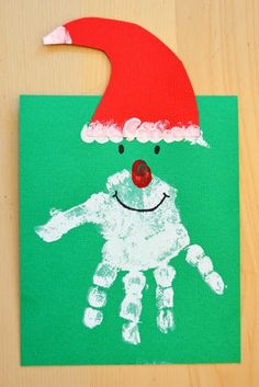 a handprint santa hat is on top of a green square with a red nose