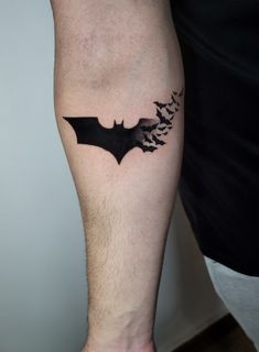 a man's leg with a bat tattoo on it