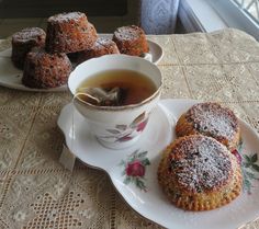 tea and pastries on a plate with a cup of tea in the foreground