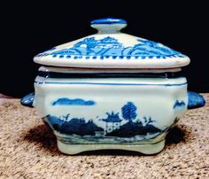 a blue and white container sitting on top of a counter