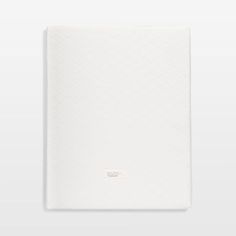 an open white notebook with the cover folded over it's side, on a gray background