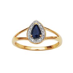 a gold ring with a blue tear shaped stone and white diamonds on the side, set in