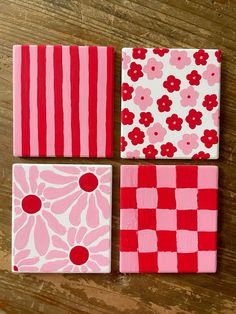 four pieces of red and white painted on wooden boards with flowers in the middle, one is