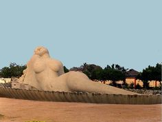 there is a large sand sculpture in the middle of a field