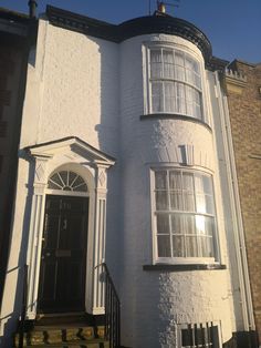 a white house with a black door and windows