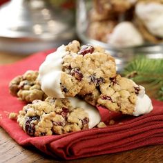 three cookies are stacked on top of each other with icing and cranberries