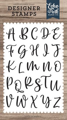 the alphabet and numbers are hand drawn in black ink on a wooden background with white scall