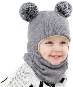 a young child wearing a gray hat and scarf