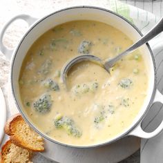 broccoli and cheese soup in a pot with a spoon