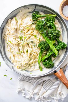 broccoli and noodles are in a pan on the table