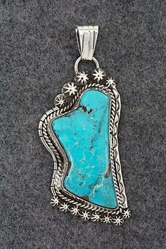 This turquoise and sterling silver pendant was made by Navajo silversmith Rita Largo. The back is signed RL and stamped sterling.Height: 3"Width: 1 1/4"Free shipping on all orders! We ship with USPS and always include tracking. All orders ship within a day of payment.Returns are accepted up to 30 days after you receive your order. Just send us a message. Our shop offers cash back or store credit. The item must be returned in new condition. Western Style Collectible Turquoise Sterling Silver Necklace, Southwestern Engraved Turquoise Necklace In Sterling Silver, Western-style Sterling Silver Turquoise Pendant Necklace, Western Sterling Silver Turquoise Pendant Necklace, Western Style Turquoise Pendant Necklace In Sterling Silver, Western Style Silver Turquoise Necklace With Large Pendant, Southwestern Turquoise Sterling Silver Collectible Necklace, Southwestern Sterling Silver Turquoise Necklace Collectible, Southwestern Engraved Turquoise Necklace