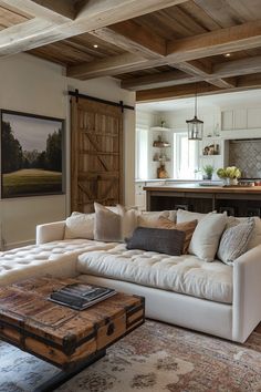 a living room filled with furniture next to a kitchen and an island in the background