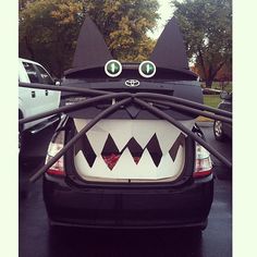 the back end of a car with black and white decorations on it