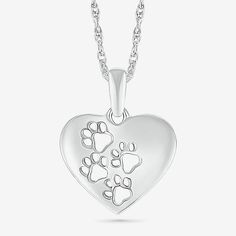 a heart shaped pendant with paw prints on it