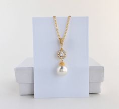 Classic pearl bridal necklace and pendant set with gold plated brass peg and bail. Necklace features a pendant with a 10mm Swarovski single pearl drop that dangles from round cubic zirconia halo connector and bail. Length of the gold plated chain is 18 inches and comes with 2 inches extender and lobster clasp. For matching earrings click: https://www.etsy.com/listing/577296408/gold-halo-pearl-bridal-earrings-gold?ref=listing-shop-header-1 For complete set click: https://www.etsy.com/listing/5772 Gold Teardrop Pendant Bridal Necklace As Gift, Gold Bridal Necklace With Pearl Drop For Bridesmaid Gift, Gold Pearl Drop Bridal Necklace For Bridesmaid Gift, Gold Pearl Drop Necklace For Bridesmaids, Bridesmaid Jewelry Gold, Bridal Necklace Gold, Gold Bridesmaid Jewelry, Gold Crystal Necklace, Schmuck Gold