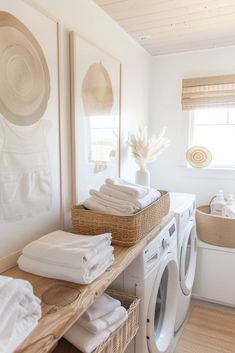 a washer and dryer in a room with towels on the shelf next to it