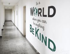 there is a sign on the wall that says in a world where you can be anything behind