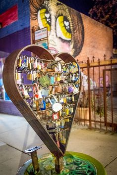 a heart shaped display on the side of a building with lots of magnets attached to it