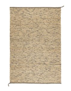 a beige rug with black speckles on it