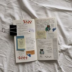 an open notebook with stickers and writing on it