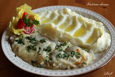 a white plate topped with mashed potatoes and meat