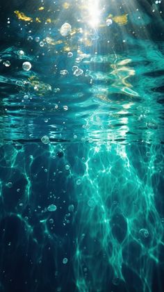 the sun shines brightly through the water's bubbles in this underwater scene photo