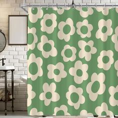 a green shower curtain with white flowers on it