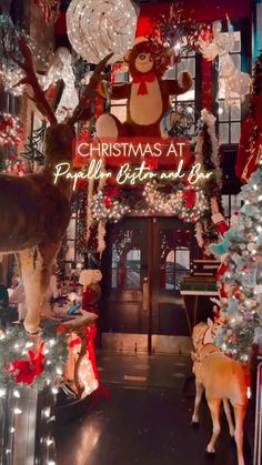 the entrance to christmas at pella's biscuit shop with reindeers and lights