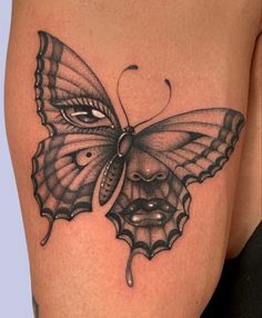 a woman's thigh with a butterfly tattoo on the side of her leg and an open mouth