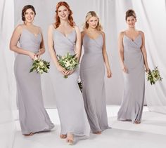 four bridesmaids in grey dresses posing for the camera