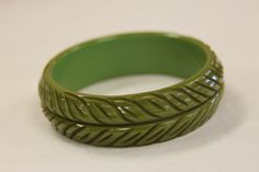 This is a set of 4 FOUR matched vintage Bakelite bangle bracelets. This set consists of a Olive green, Chocolate /brown, Black and Butterscotch bracelets each of which is a full 1 inch wide. When Bakelite bangles were originally made, the designs were often available in more than one color. In the past seventy or so years these bangles have scattered to the four corners of the earth. Reassembling a matched set today requires dedication and patience and can take years to accomplish. A fine matche Antique Green Handmade Bracelet, Handmade Antique Green Bracelet, Vintage Green Bangle Jewelry, Green Vintage Cuff Bracelet, Retro Green Bangle Bracelets, Vintage Green Cuff Bracelet For Formal Occasions, Vintage Green Cuff Bracelet For Formal Events, Vintage Adjustable Green Bangle, Green Vintage Cuff Bracelet For Formal Occasions