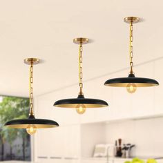 three lights hanging from the ceiling in a kitchen