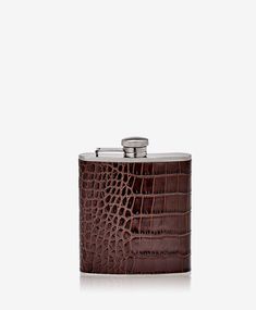 a brown leather hip flask with a stainless steel top and an alligator embossed pattern