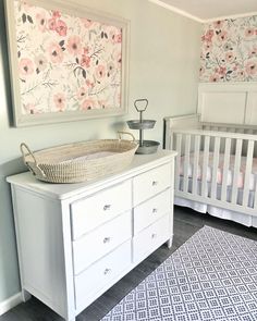 a baby's room with a crib, dresser and changing table in it