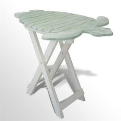 Decorate with the cute Coastal Sea Turtle Accent Table. The handcrafted, slatted wood tray table is handpainted with a wax finish. The sea turtle top is seafoam green, and the legs are white. Indoor or covered outdoor use. Coastal table is 19"Wx14"Dx20"H.    Handcrafted wood coastal accent table   Slatted tray table has a handpainted wax finish   Sea turtle top is seafoam green   Indoor or covered outdoor use   "/search.aspx?ss=177COL"   Click Here    to view the entire Coastal Accent Table Coll Coastal Accent Table, Turtle Top, Beachy Room, On A Boat, Side And End Tables, Mirrored Furniture, Accent Tables, Wood Tray, Tray Table