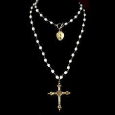 The Notre Dame Sacred Heart Rosary in freshwater pearls features a gold French Sacred Heart Cross that has a lily flower on the reverse. At 36" it is long enough to double and when you doubled a gold dipped medal featuring our Nortre Dame - the Holy Mother the cathedral in Paris is named after her can be seen in the background. This rosary inspired necklace can be worn long or double wrapped. It is available in any length of your choice as well at other gemstones or crystal colors by custom orde Crystal Cross Necklace, Pearl Rosary Necklace, Rosary Necklace Aesthetic, Rosary Aesthetic, Rosary Inspired Necklace, Catholic Cross Necklace, A Lily Flower, Sacred Heart Necklace, Rosary Cross