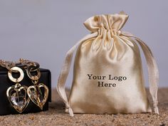 two small bags with personalized jewelry on them