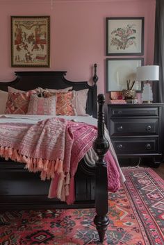 a bedroom with pink walls and black furniture